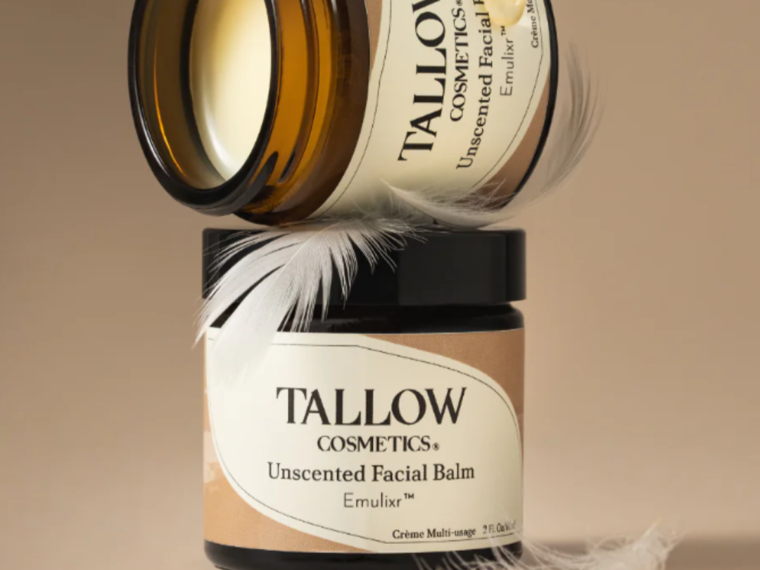 Tallow Cosmetics products on stone props—Magnesium Deodorant, skin creams, and SPF—shot in warm studio light.